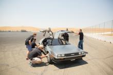 Photo of MARTY with doors open and researchers working on car