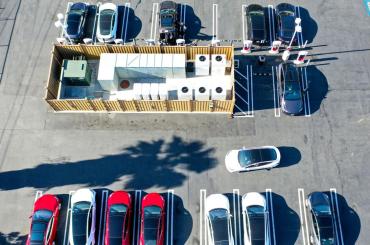 Aerial view of EVs charging at a charging station.