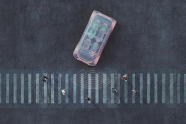 Overhead graphic of a crosswalk with pedestrians with a stylized vehicle that looks like a computer turning into the crosswalk.