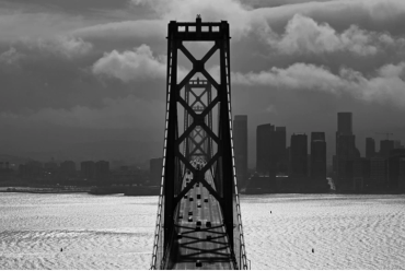 Storm clouds cover the sky as traffic moves westbound on the San Francisco Bay Bridge in San Francisco, Calif., on Monday, February 15, 2021.