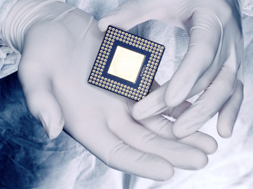 Two gloved hands holding a chip