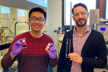 Chengshuang Zhou holds vials of ruthenium, left, and the coated catalyst, while Matteo Cargnello holds the pipe used for the reaction experiments. (Image credit: Mark Golden)