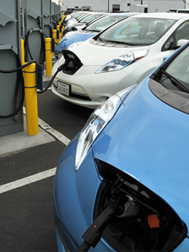 Photo of row of EV's charging at a charging station