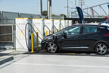 A vehicle charging at an EV charging station