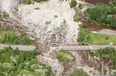 A road washed away by floodwater.