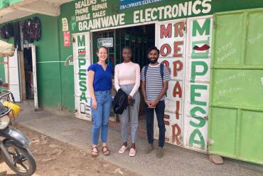 Members of a Stanford student-led team working to increase access to quality electronics repairs in emerging markets stand outside an electronics repairs shop in Narok, Kenya. Left to right: Stanford MBA graduate Sarah Johnson and teammates Ritah Wangila and Ketan Tailor. (Image credit: Urbanus Wambua)