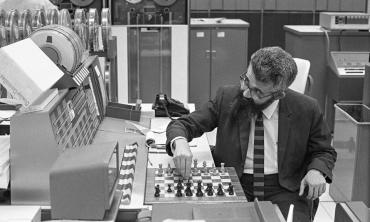 Photo of John McCarthy, a computer scientist who is credited with creating the term "artificial intelligence," plays chess against a computer in this photograph from 1966. | Chuck Painter