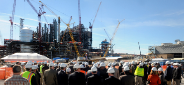 Photo of workers at a construction site some wearing hard hats.