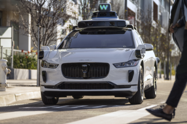 Photo of a white Waymo SUV